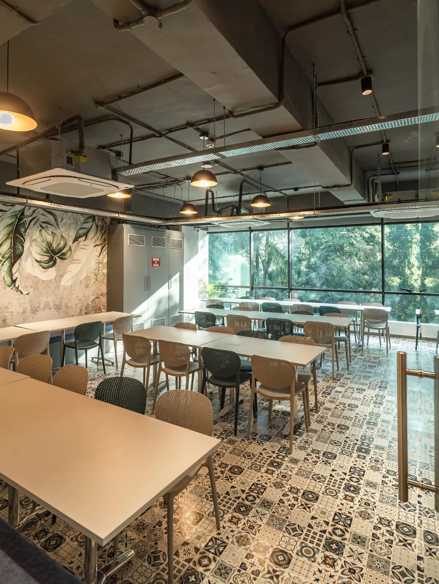 Long Cafe Tables Under Pendant Lights at YesssWorks Goregaon