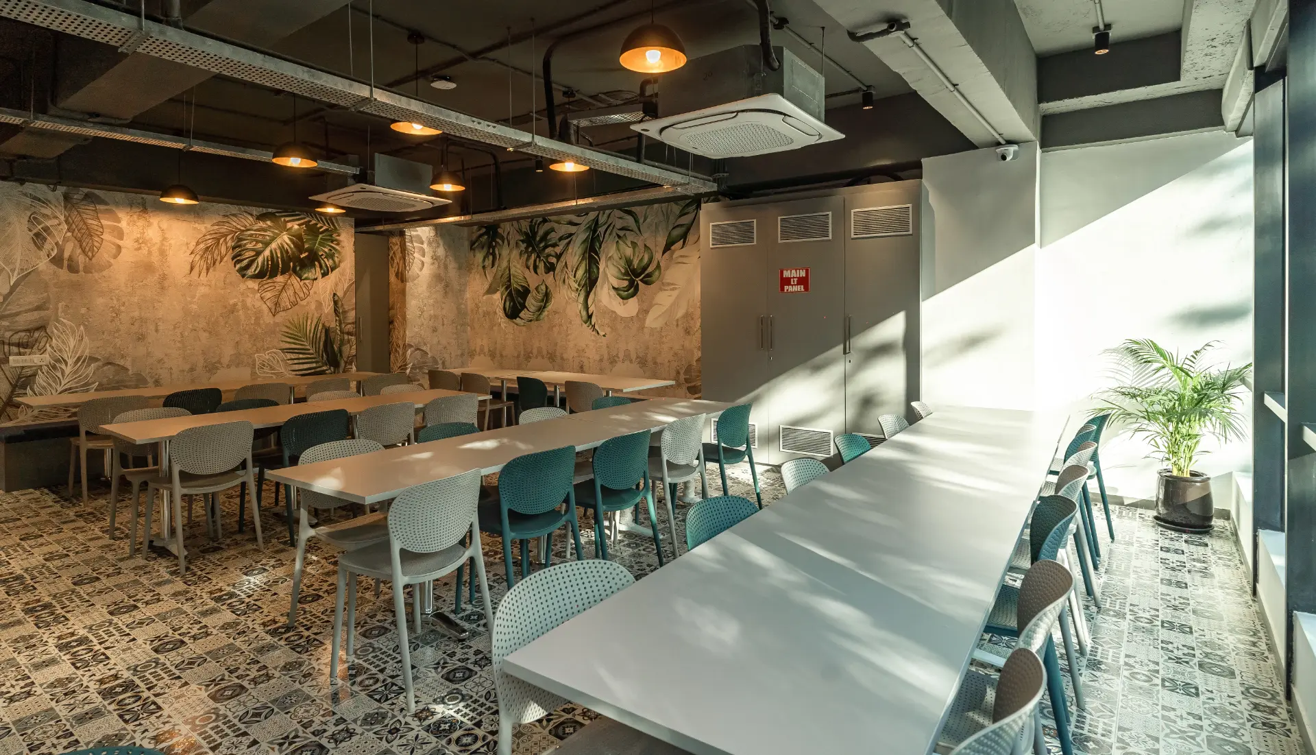 Canteen Tables Under Warm Pendant Lights at YesssWorks Goregaon