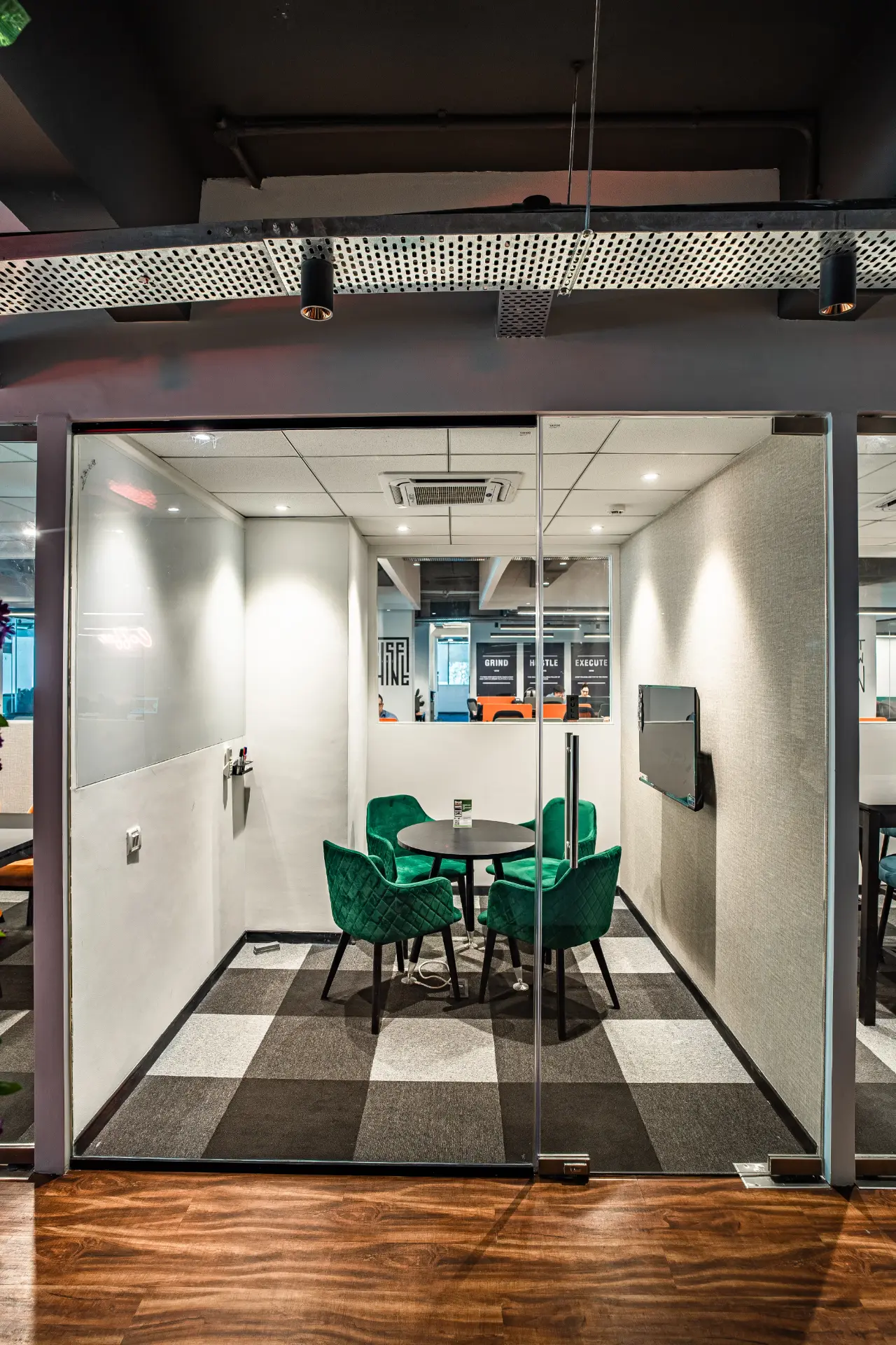 Four Seat Huddle Room with Green Chairs at YesssWorks Goregaon