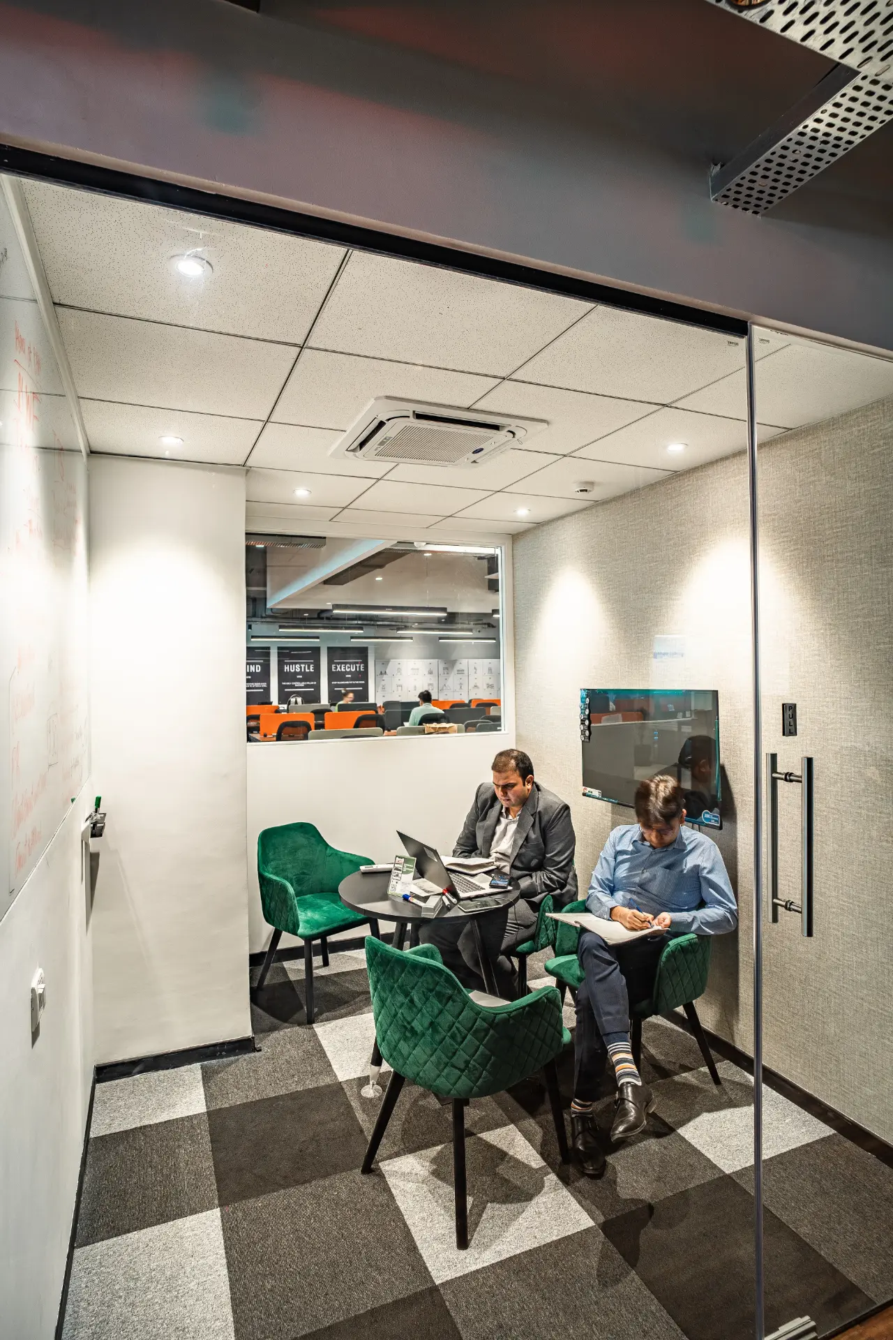 Two Members Working Inside the Huddle Room at YesssWorks Goregaon, 271 Business Park